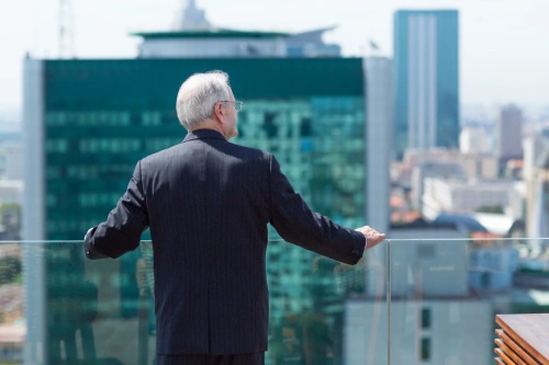 Retired business founder overlooking city skyline